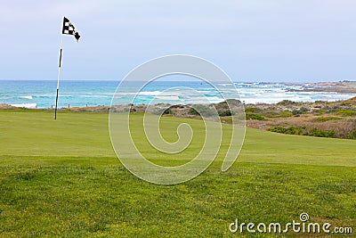 Beautiful golf hole green with flag on California ocean coast