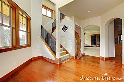 Beautiful home entrance with wood floor. New luxury home interior.