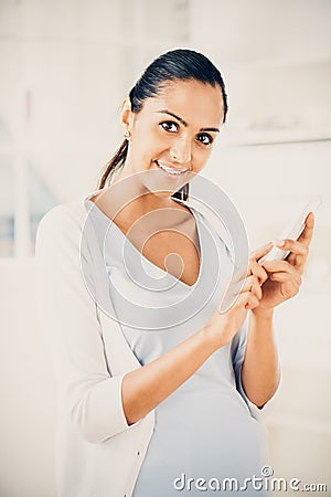 Beautiful Indian woman using mobile phone happy