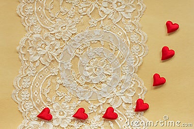 Beautiful lace on paper with red hearts