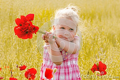 Beautiful little girl with a bouquet of red flowers