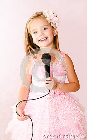 Beautiful little girl with microphone