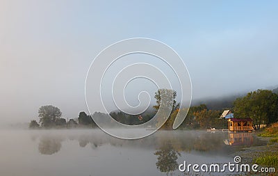 Beautiful misty landscape on a pond with pavilion