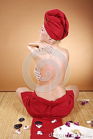 Beautiful model at wellness massage with hot stone
