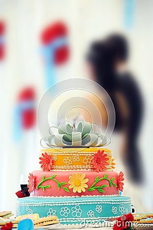 Beautiful multi-tiered wedding cake and couple