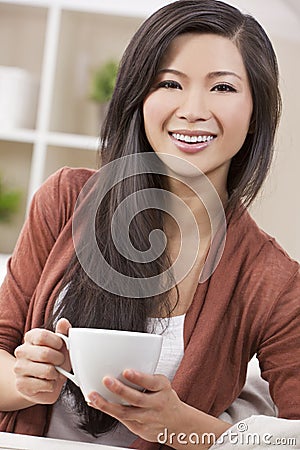 Beautiful Oriental Woman Drinking Tea or Coffee
