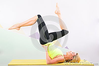 Beautiful pilates instructor with yellow yoga mat