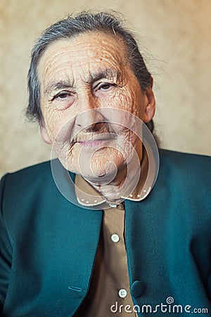 Beautiful 80 plus year old senior woman posing for a portrait in her house.