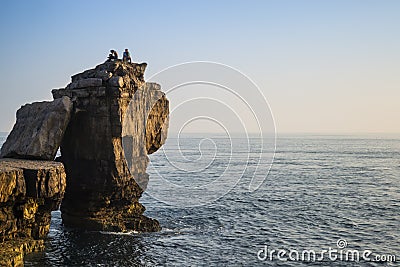 Beautiful rocky cliff landscape with sunset over ocean with undi