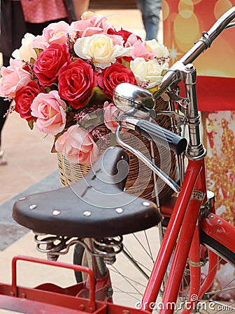 Beautiful of rose artificial flowers in vintage bicycle