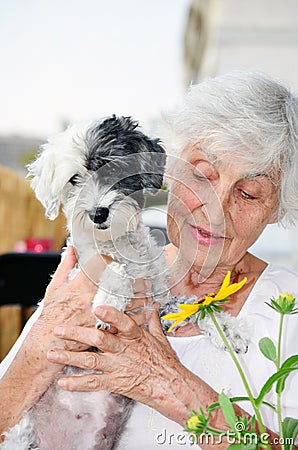 Beautiful senior woman hugging her dog