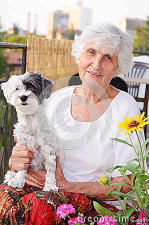 Beautiful senior woman hugging her dog