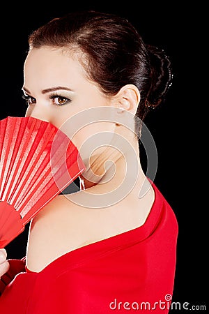 Beautiful sexy woman in red dress and fan.