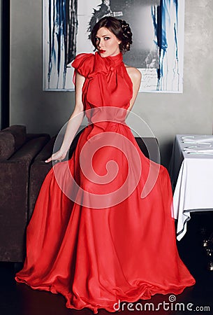 Beautiful sexy woman in red long evening dress of silk