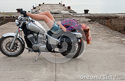 Beautiful, sexy, young woman on a motorcycle