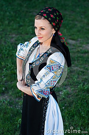 Beautiful singer posing in traditional costume, romanian f