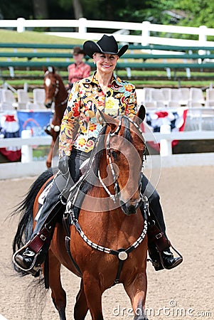 A Beautiful Smiling Senior Citizen Rides A Horse At The Germantown Charity Horse Show