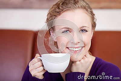 http://thumbs.dreamstime.com/x/beautiful-smiling-woman-enjoying-cup-coffee-shop-31343513.jpg