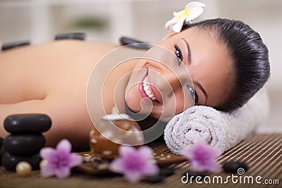 Beautiful smiling woman relaxing in spa center