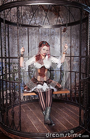 Beautiful steampunk woman in the cage