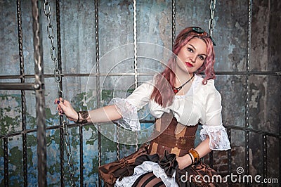 Beautiful steampunk woman in the cage