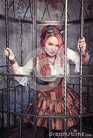 Beautiful steampunk woman in the cage