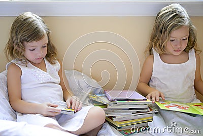 Beautiful twin little girls doing homework