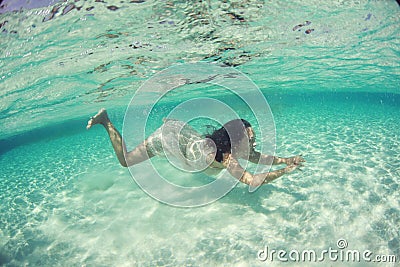 Beautiful underwater bride in Maldives woman diving sea