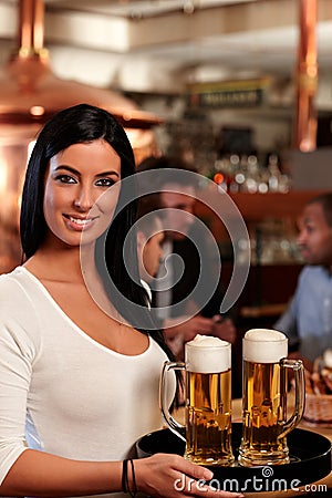 Beautiful waitress serving beer