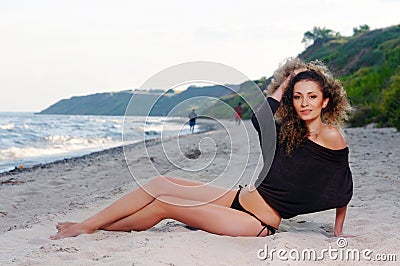 http://thumbs.dreamstime.com/x/beautiful-woman-bathing-suit-standing-beach-sunset-30629455.jpg