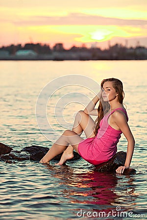 Beautiful woman on the beach at sunset. Enjoy nature. Luxury gir