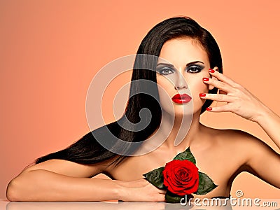 Beautiful woman with bright fashion makeup and red nails.
