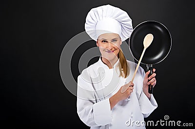 Beautiful woman chef holding pan on white dark background