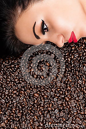 Beautiful woman in coffee beans