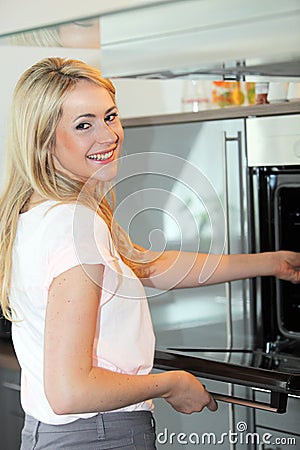 Beautiful woman cooking in her kitchen