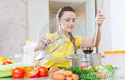 Beautiful woman cooking vegetarian food