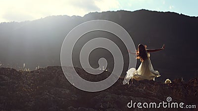 Beautiful woman dancing in evening light