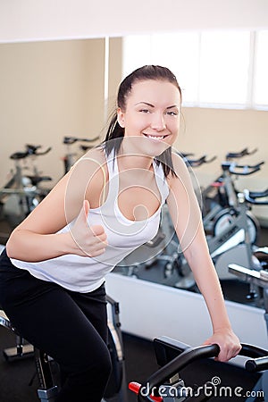 Beautiful woman on an exercise bike