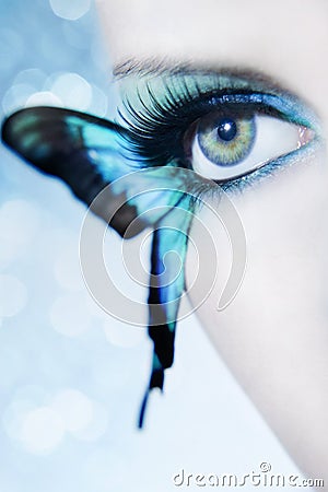 Beautiful woman eye close up with butterfly wings