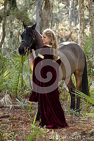 Beautiful woman in formal dress and horse