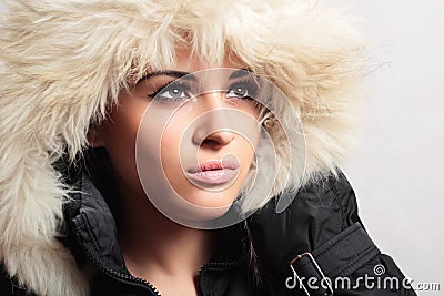 Beautiful woman with fur. white fur hood. winter style. make-up. fashion beauty girl.