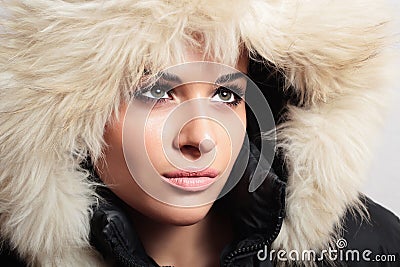 Beautiful woman with fur. white fur hood. winter style. make-up. fashion beauty girl.