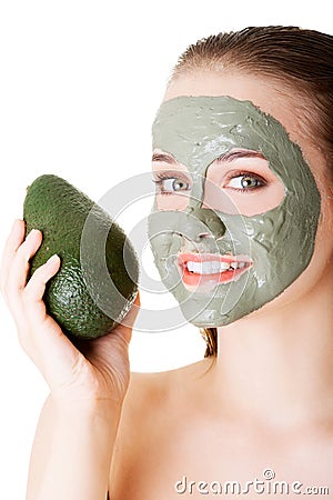 Beautiful woman with green avocado clay facial mask