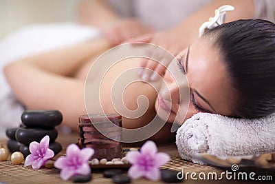 Beautiful woman having a wellness back massage at spa salon