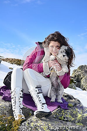 Beautiful woman and her dog in the mountain