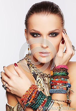 http://thumbs.dreamstime.com/x/beautiful-woman-jewelry-portrait-young-brunette-collar-multiple-bracelets-gray-33981687.jpg