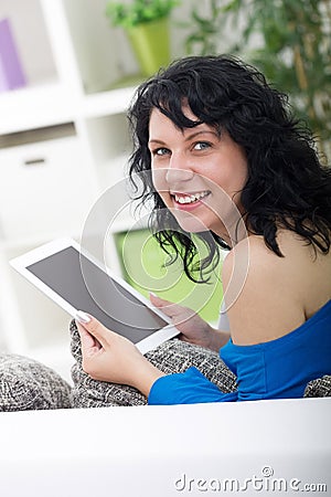 Beautiful woman laughs and holds in his hand digital tablet