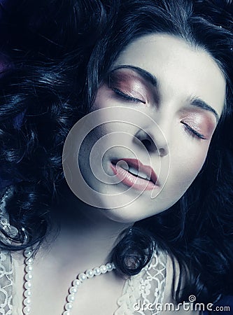 Beautiful woman lay on organza. Sleeping beauty.