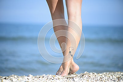 Beautiful woman legs on the beach