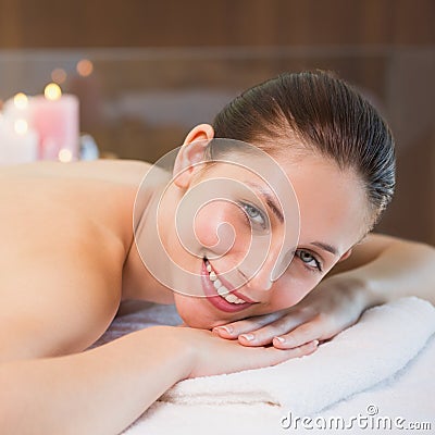 Beautiful woman lying on massage table at spa center